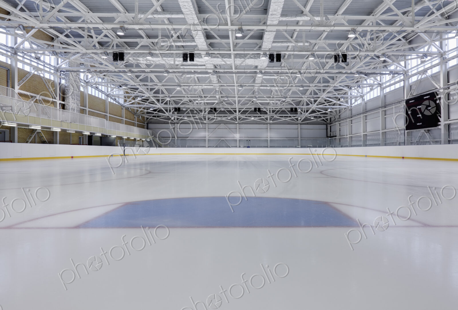 Interior view of an ice rink with ice hockey markings.