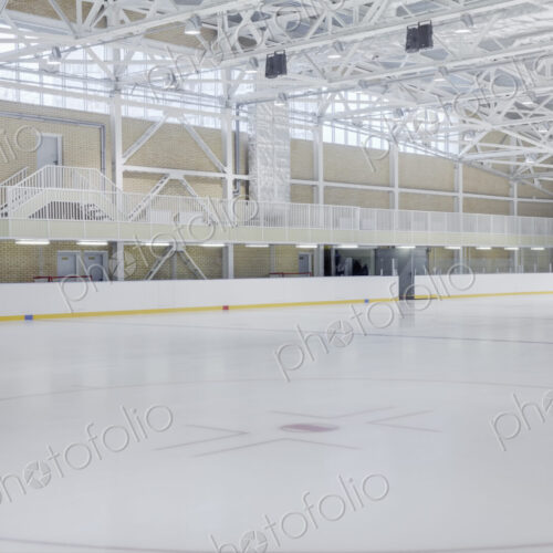 Interior view of an ice rink with ice hockey markings.