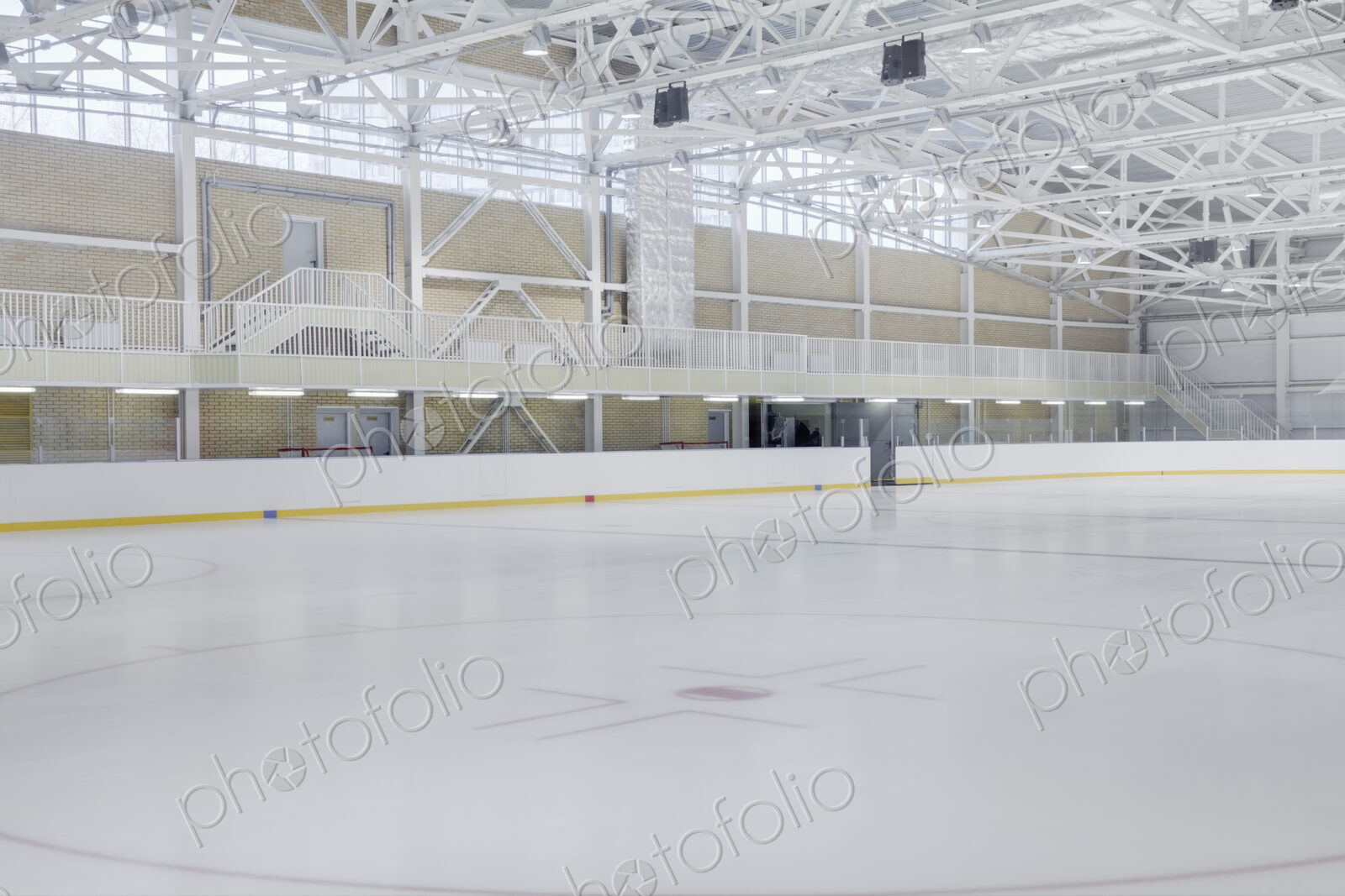 Interior view of an ice rink with ice hockey markings.