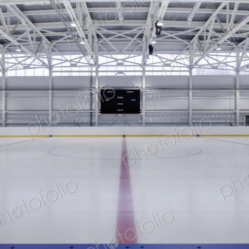 Interior view of an ice rink with ice hockey markings.