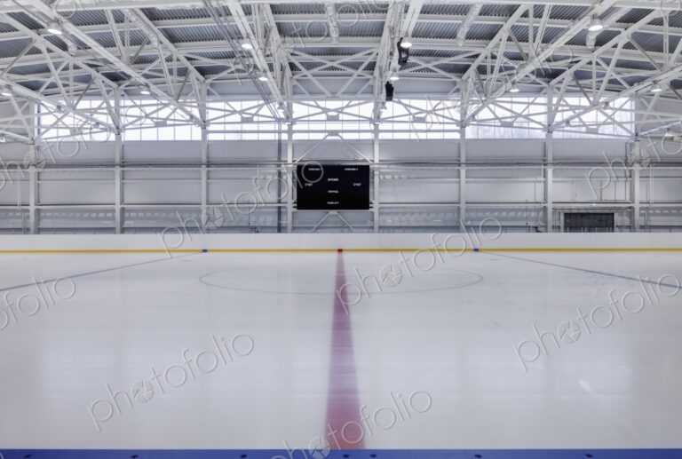 Interior view of an ice rink with ice hockey markings.