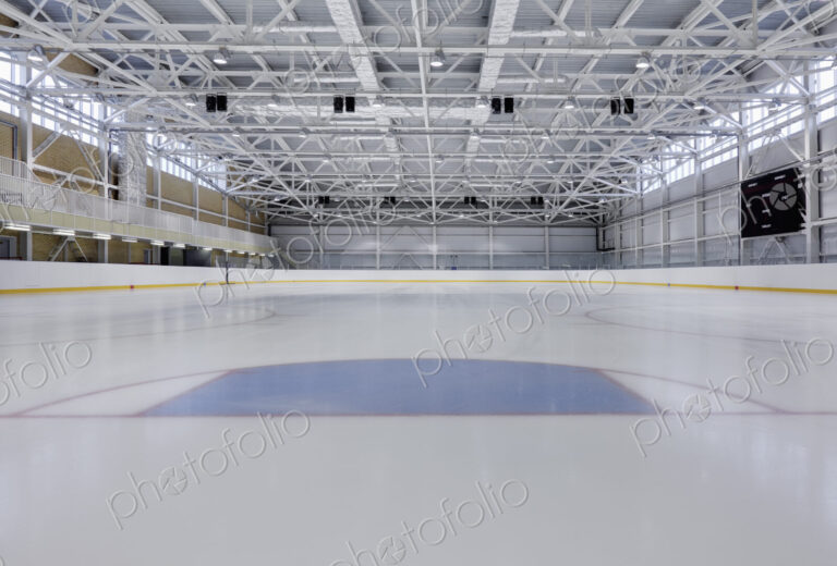 Interior view of an ice rink with ice hockey markings.