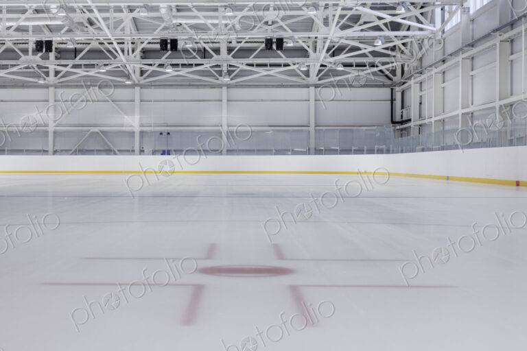 Interior view of an ice rink with ice hockey markings.