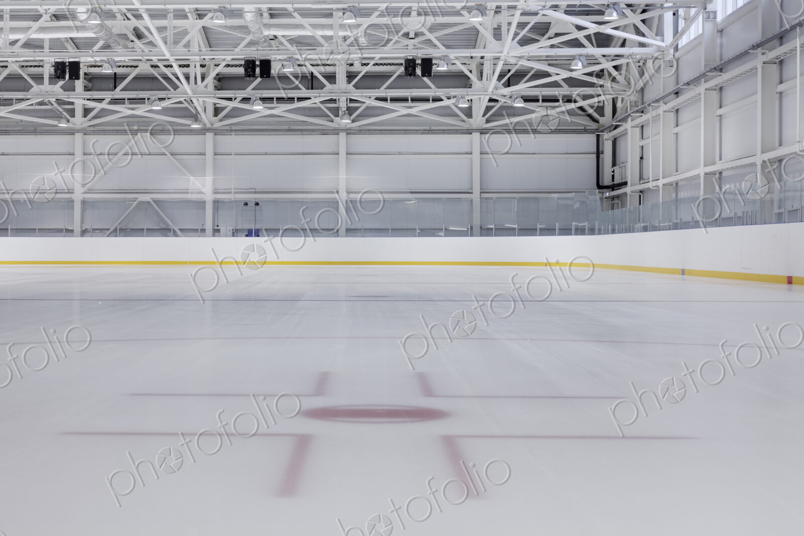 Interior view of an ice rink with ice hockey markings.