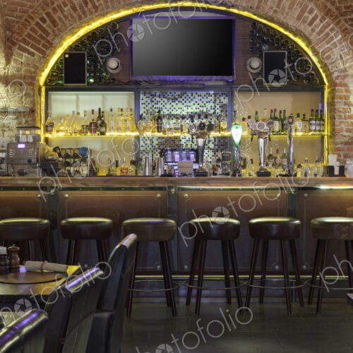 Interior view of bar with big TV screen on wall. Interior view of bar with big TV screen on wall.