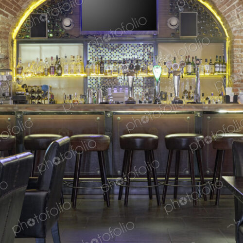 Interior view of bar with big TV screen on wall. Interior view of bar with big TV screen on wall.