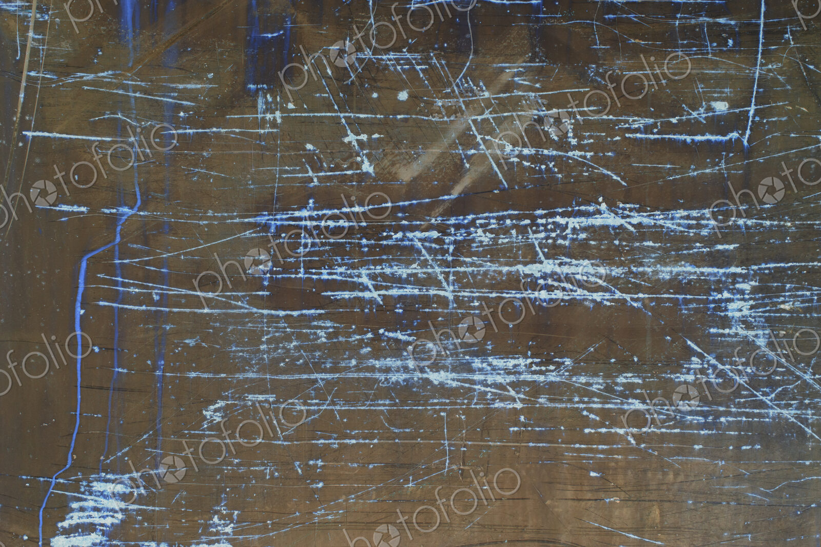 Inverted image of scratch marks and peeling paint on metal wall