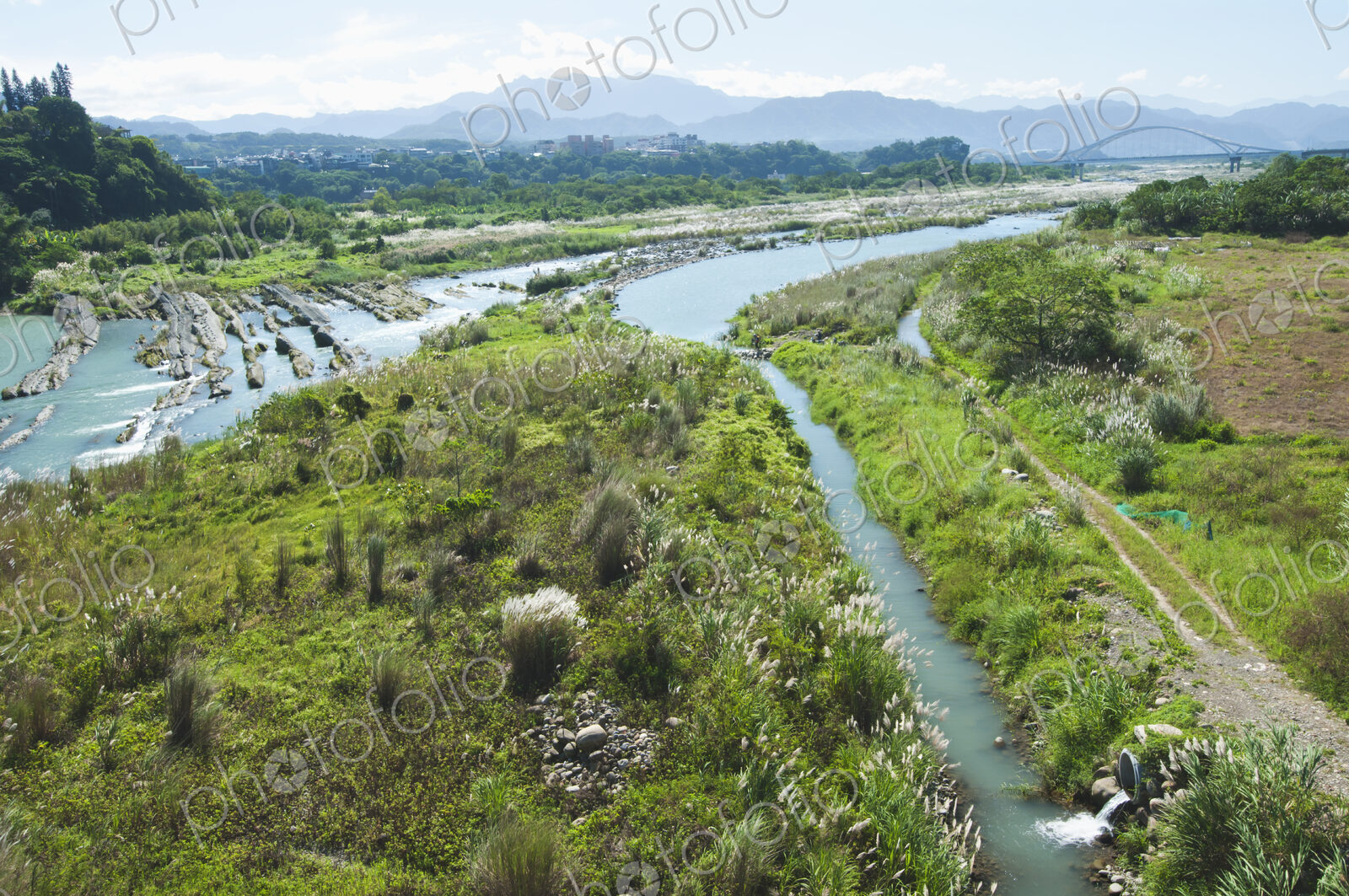 Irrigation channels and a drainage overflow ditch cut into the landscape by a river.