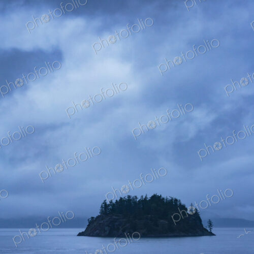 Island in the San Juan Islands group, a silhouette of Orcas Island in the sea, under a…