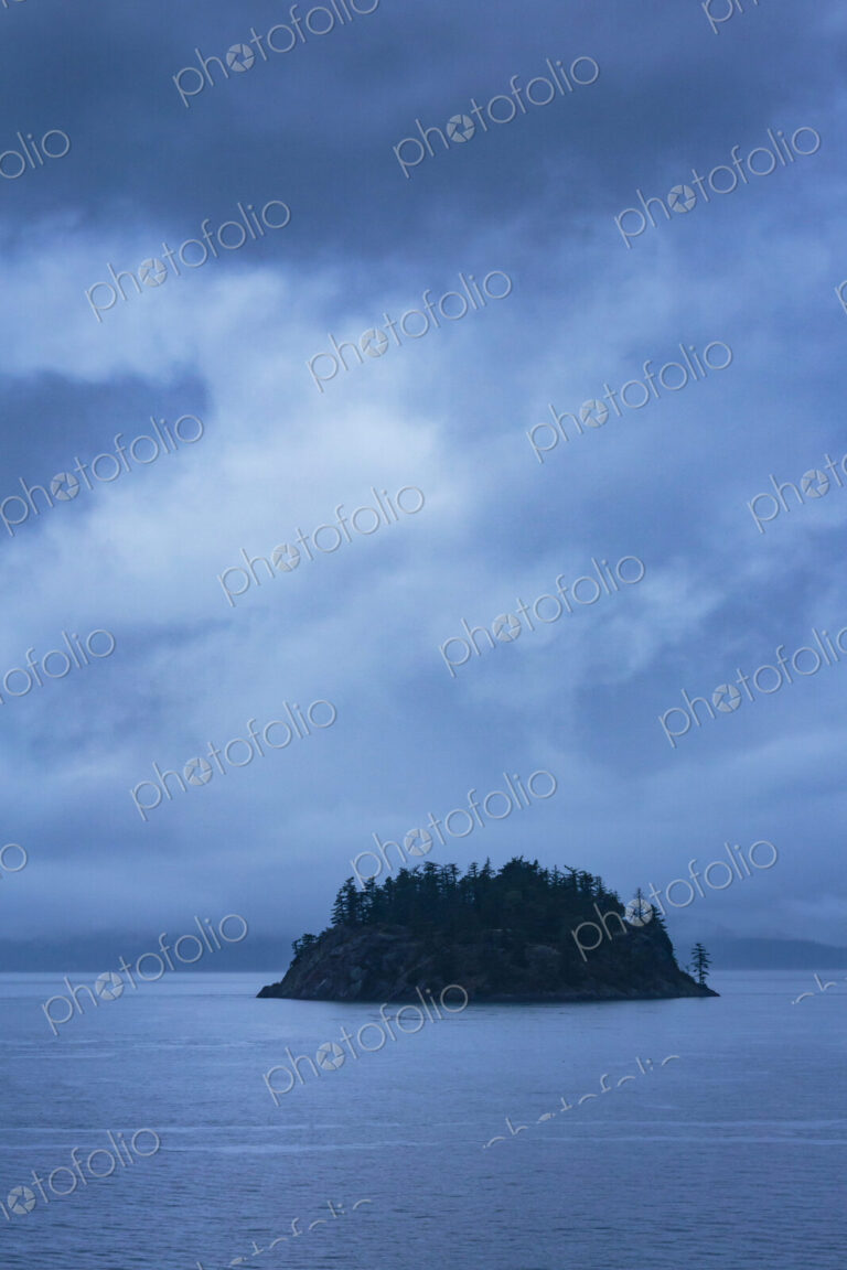 Island in the San Juan Islands group, a silhouette of Orcas Island in the sea, under a…