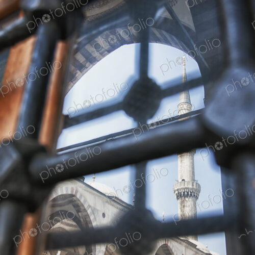 Istanbul city, a landmark, a tall minaret and arches with stonework and fretwork…