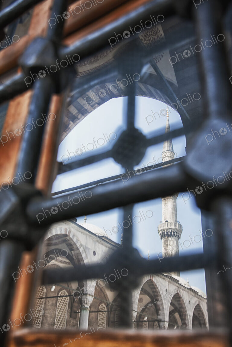 Istanbul city, a landmark, a tall minaret and arches with stonework and fretwork…