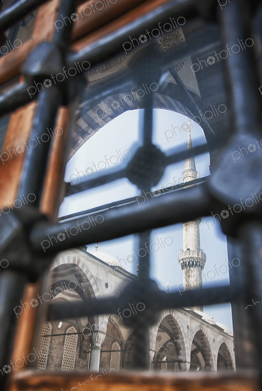 Istanbul city, a landmark, a tall minaret and arches with stonework and fretwork…