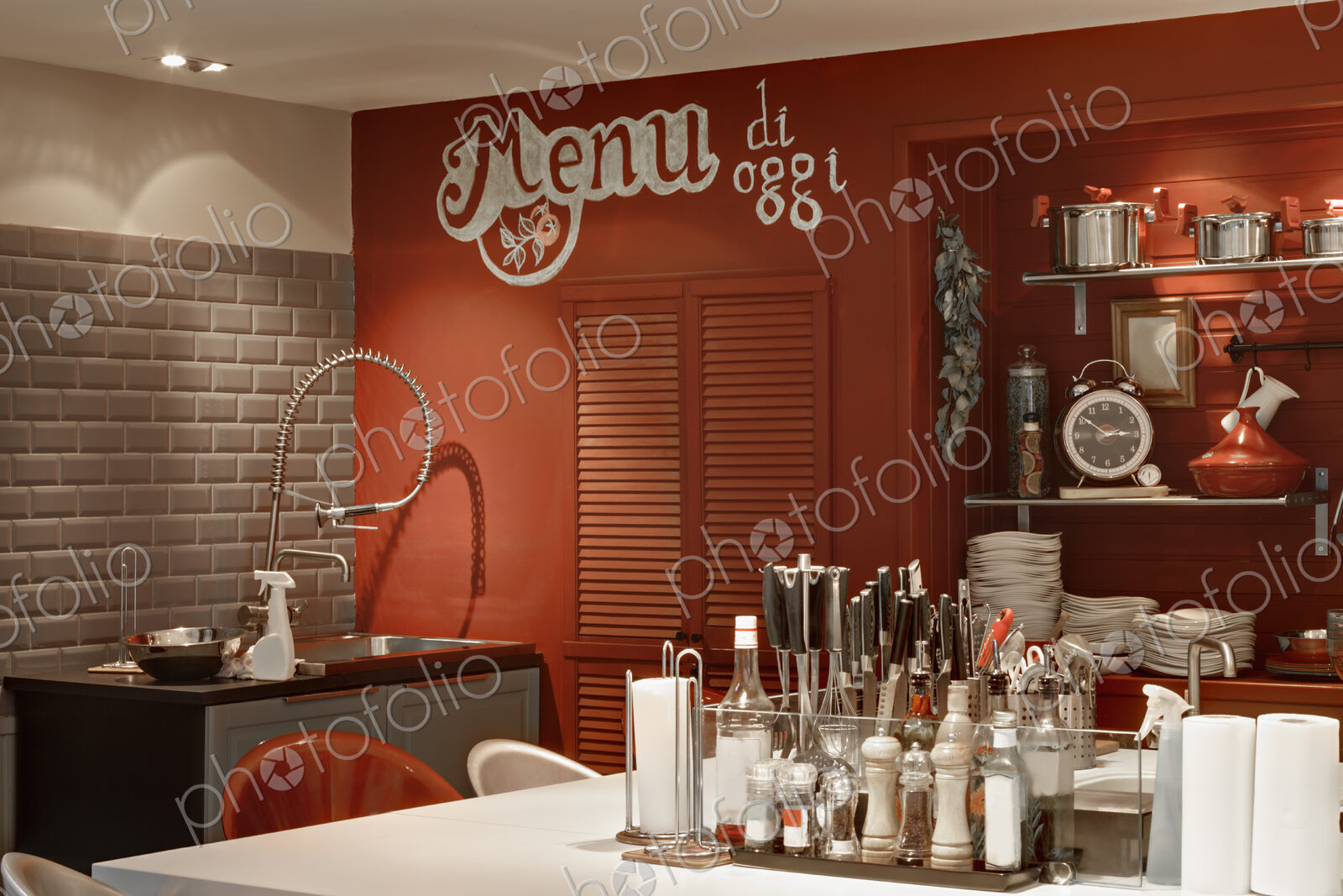 Italian themed kitchen with island covered in condiments and seasonings.