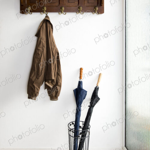 Jacket and umbrellas in foyer of home