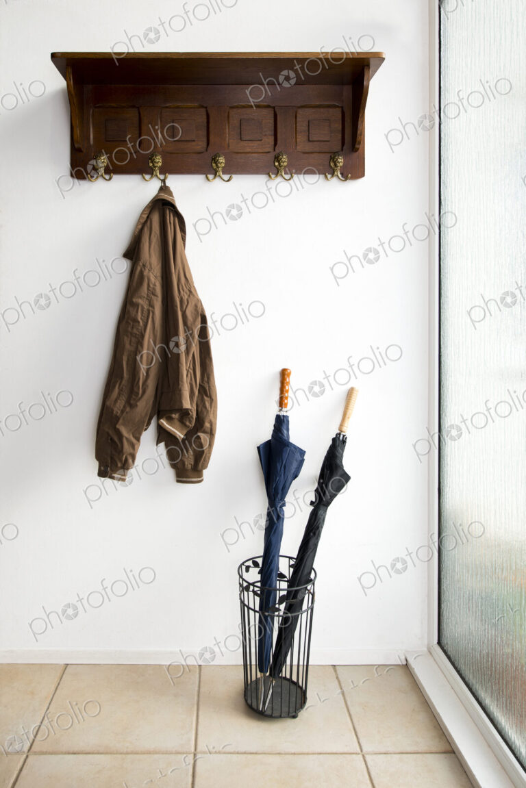 Jacket and umbrellas in foyer of home
