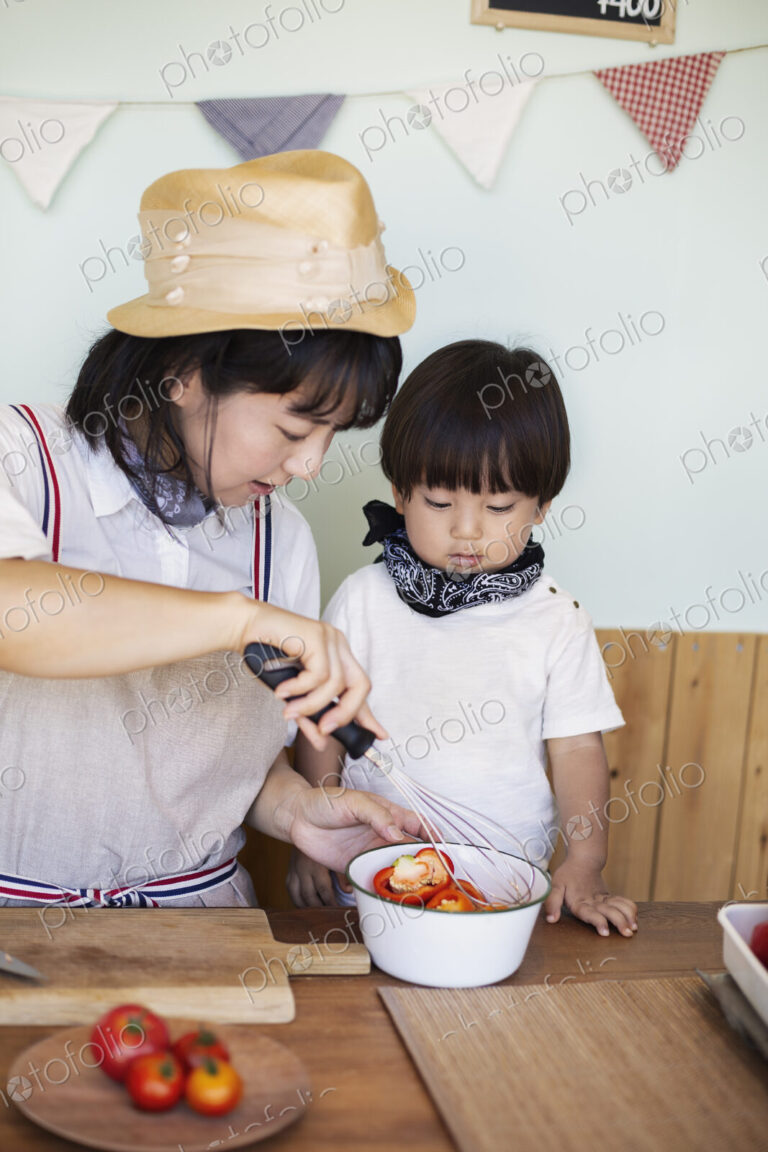 Japanese woman and boy standing in a farm shop, preparing food.