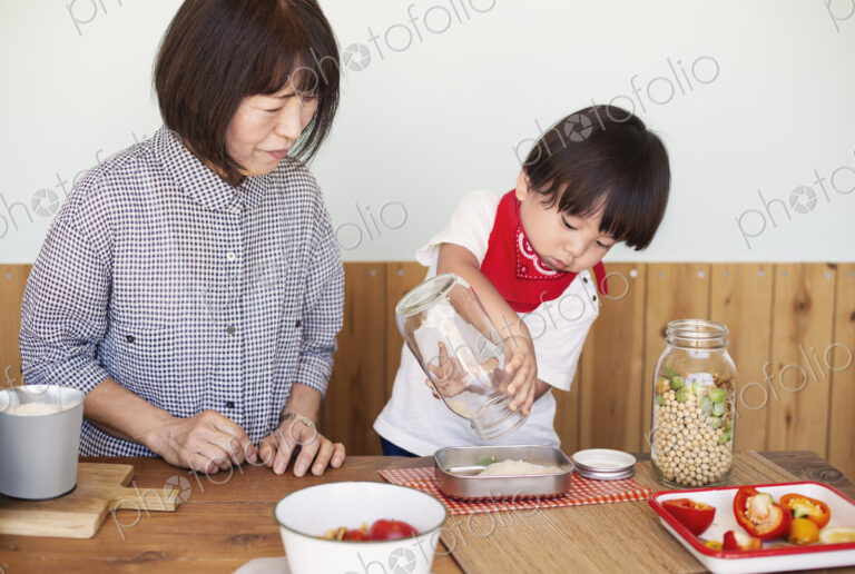 Japanese woman and boy standing in a farm shop, preparing food.