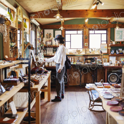 Japanese woman browsing merchandise in a leather shop. Japanese woman browsing merchandise in a leather shop.