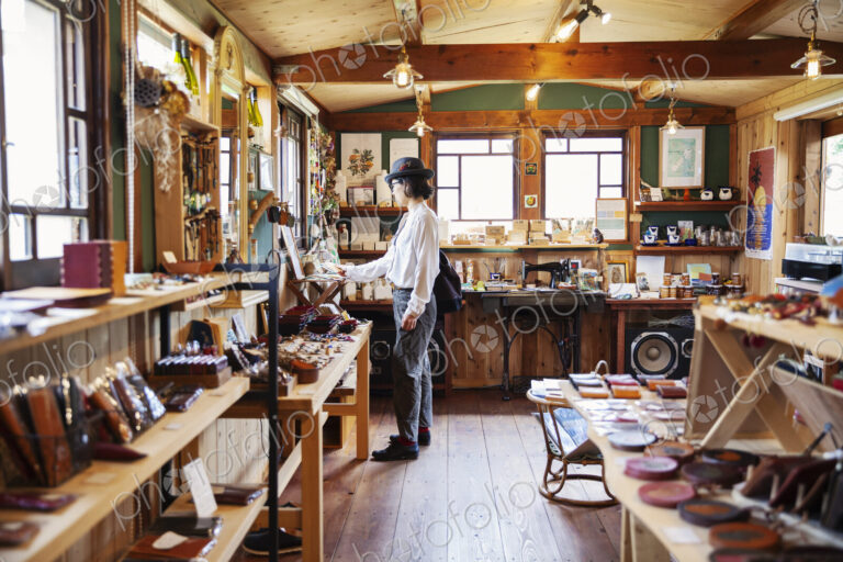 Japanese woman browsing merchandise in a leather shop.