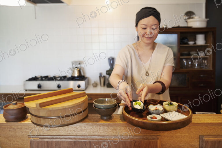 Japanese woman preparing food in a vegetarian cafe.