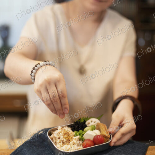 Japanese woman preparing fresh vegetables in a vegetarian cafe. Japanese woman preparing fresh vegetables in a vegetarian cafe.