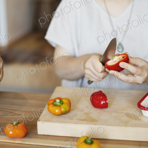 Japanese woman preparing fresh vegetables in a vegetarian cafe. Japanese woman preparing fresh vegetables in a vegetarian cafe.