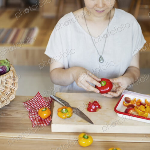 Japanese woman preparing fresh vegetables in a vegetarian cafe. Japanese woman preparing fresh vegetables in a vegetarian cafe.