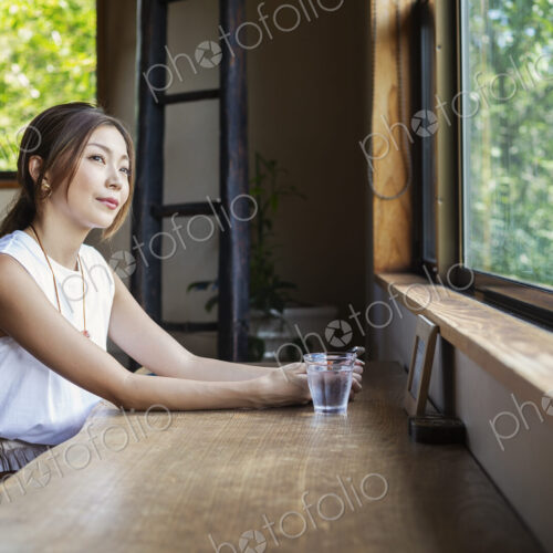 Japanese woman sitting at a table in a Japanese restaurant. Japanese woman sitting at a table in a Japanese restaurant.