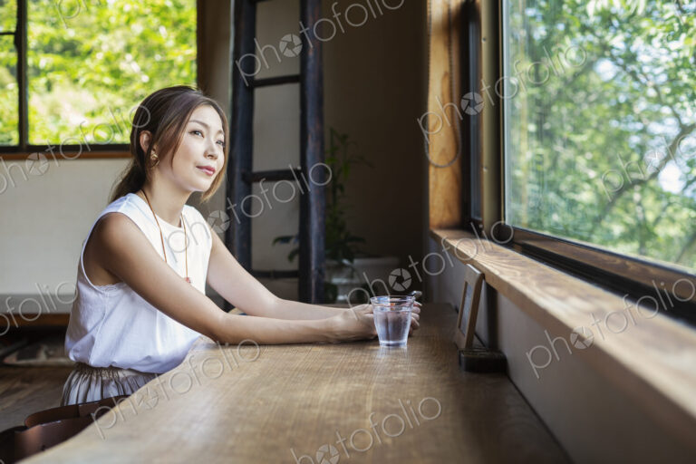 Japanese woman sitting at a table in a Japanese restaurant.