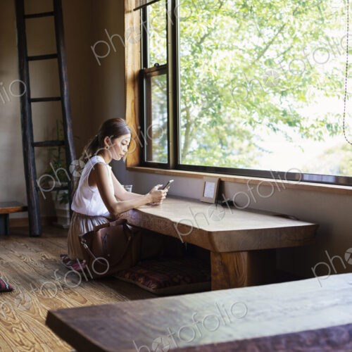 Japanese woman sitting at a table in a Japanese restaurant. Japanese woman sitting at a table in a Japanese restaurant.