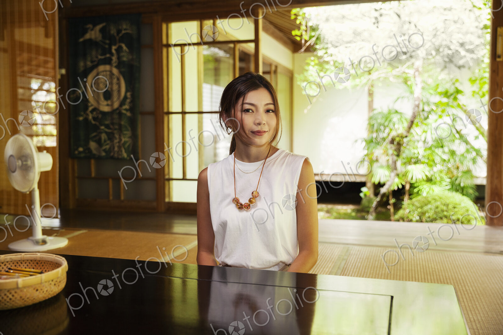 Japanese woman sitting in Buddhist temple.