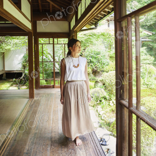 Japanese woman standing in Buddhist temple. Japanese woman standing in Buddhist temple.