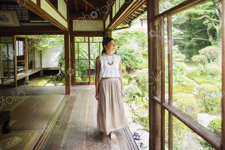 Japanese woman standing in Buddhist temple.