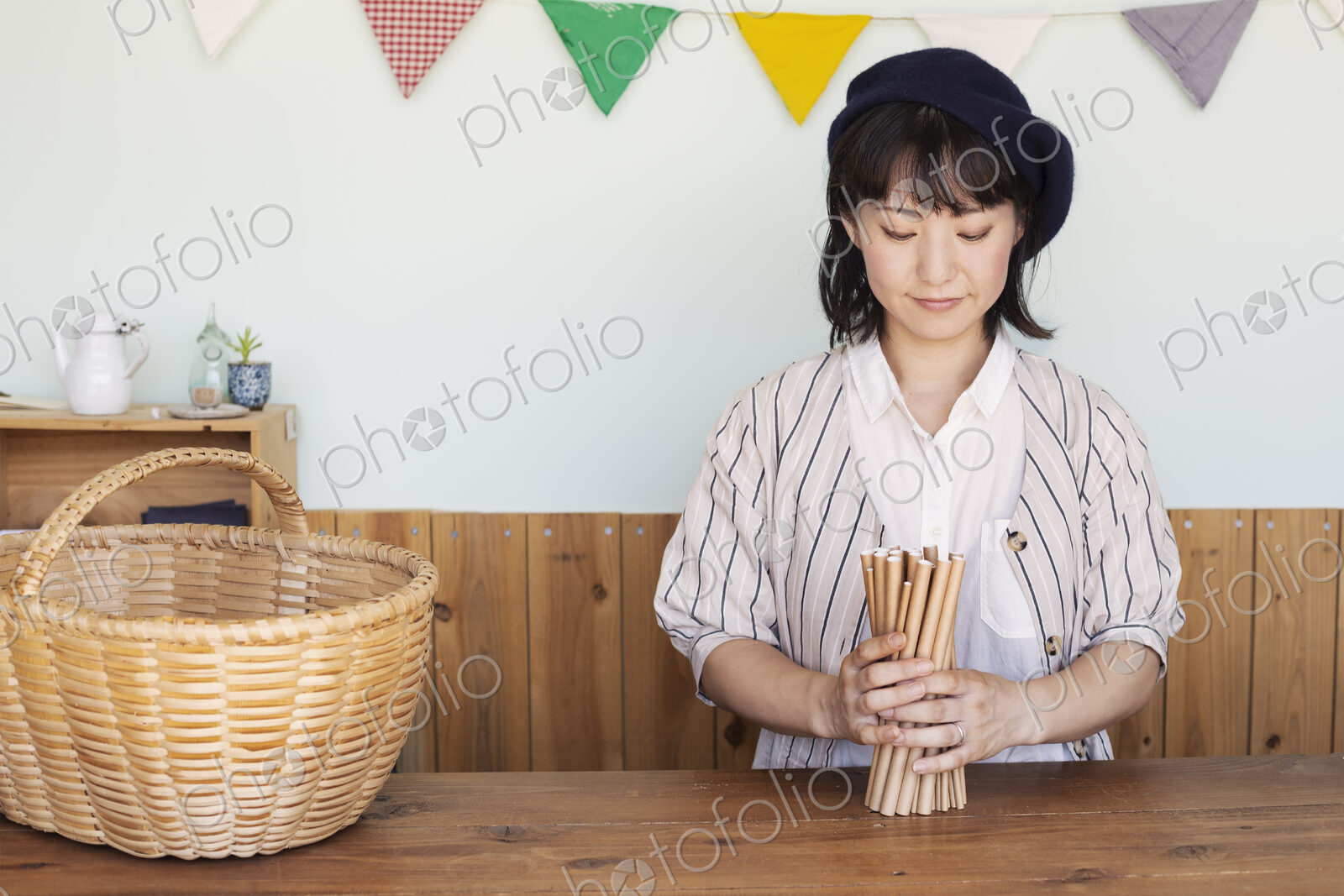 Japanese woman standing next to a basket behind counter in a farm shop.
