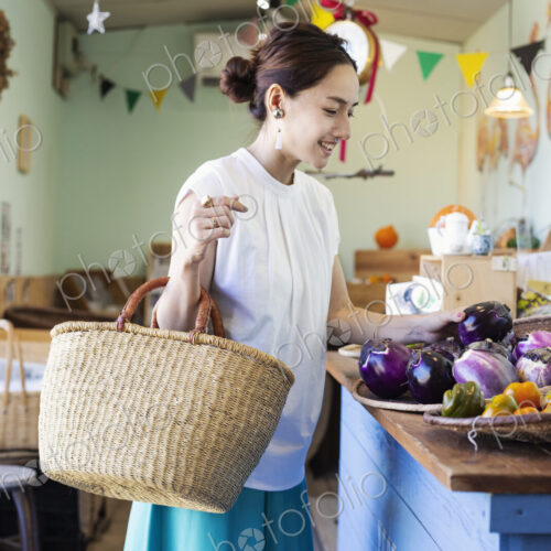 Japanese women shopping fresh vegetables in a farm shop. Japanese women shopping fresh vegetables in a farm shop.
