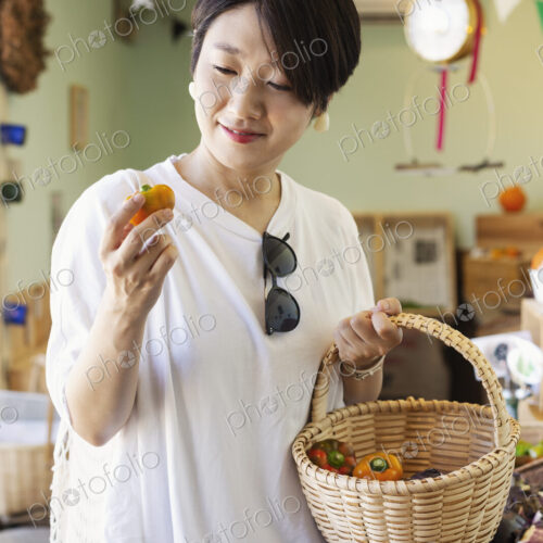 Japanese women shopping fresh vegetables in a farm shop. Japanese women shopping fresh vegetables in a farm shop.