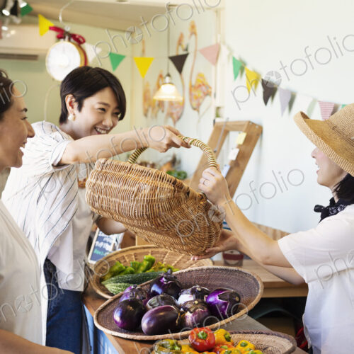 Japanese women shopping fresh vegetables in a farm shop. Japanese women shopping fresh vegetables in a farm shop.
