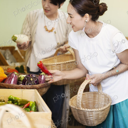 Japanese women shopping fresh vegetables in a farm shop. Japanese women shopping fresh vegetables in a farm shop.