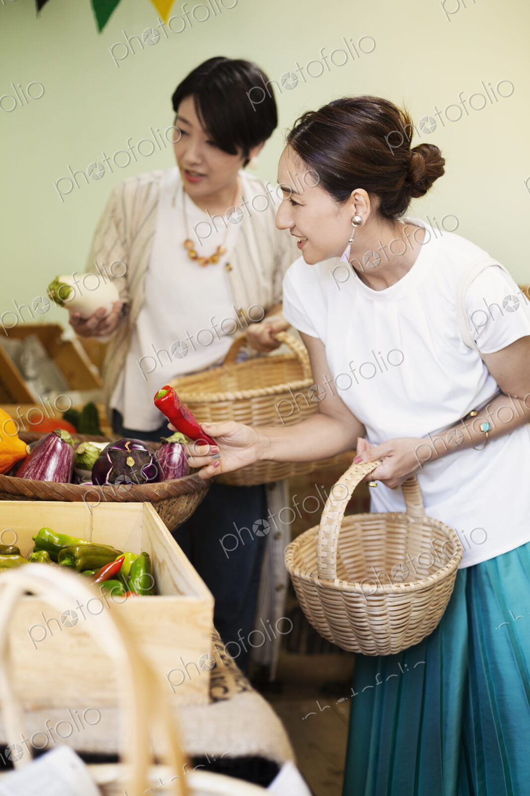 Japanese women shopping fresh vegetables in a farm shop.