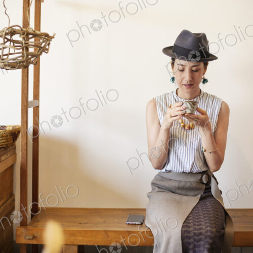 Japanese women wearing hat drinking tea in a vegetarian cafe. Japanese women wearing hat drinking tea in a vegetarian cafe.