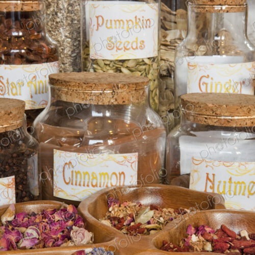Jars of seeds and plant material, herbs on shelves in an apothecary shop. Jars of seeds and plant material, herbs on shelves in an apothecary shop.