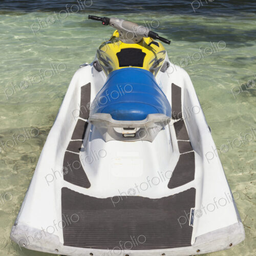 Jet ski in shallow water at the water's edge on the beach Jet ski in shallow water at the water's edge on the beach