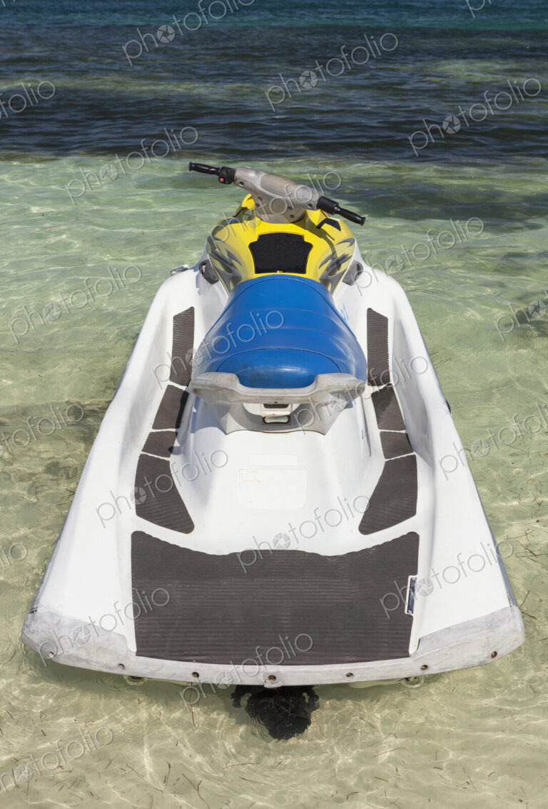 Jet ski in shallow water at the water's edge on the beach