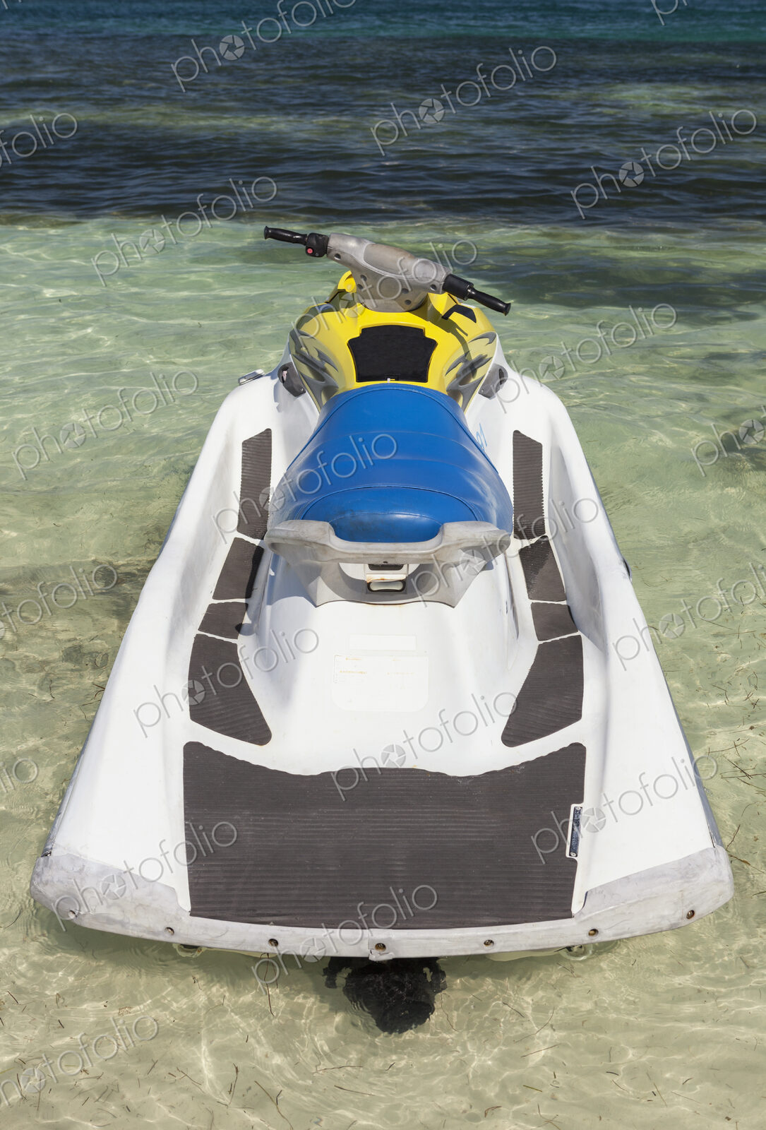 Jet ski in shallow water at the water’s edge on the beach