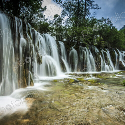 Jiuzhaigou Waterfall, water cascading over rocks in a national park, an Unesco world… Jiuzhaigou Waterfall, water cascading over rocks in a national park, an Unesco world…