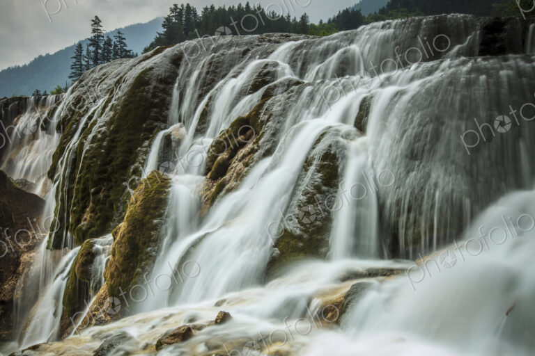 Jiuzhaigou Waterfall , water cascading over rocks in a national park, an Unesco world…
