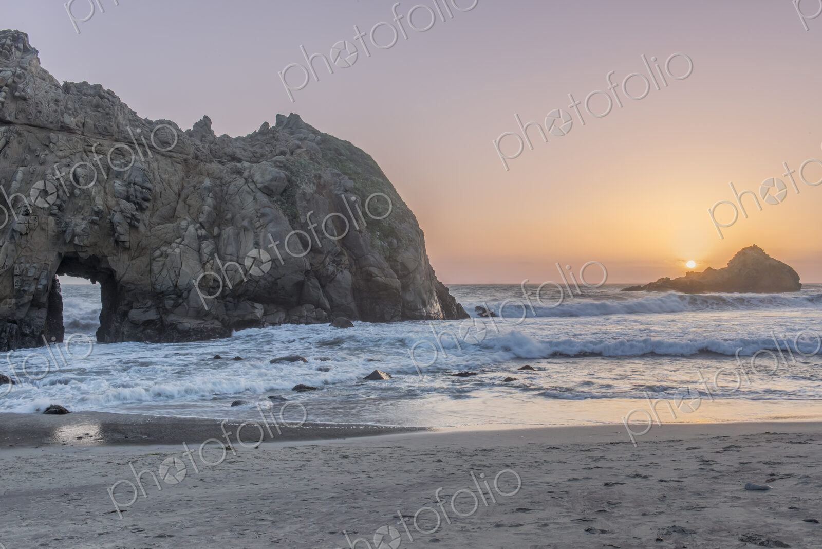 Julia Pfeiffer Burns State Park, view of the rock arch and headland at sunset.