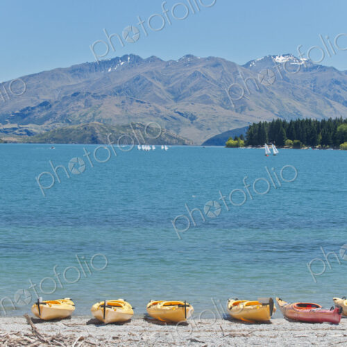 Kayaks docked along beach, Lake Wanaka, Otago, New Zealand Kayaks docked along beach, Lake Wanaka, Otago, New Zealand
