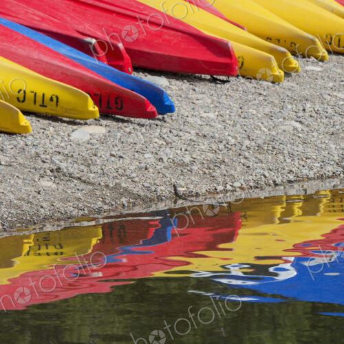 Kayaks for hire, laid out on the shores of Colter Bay at Jackson lake in the Grand…